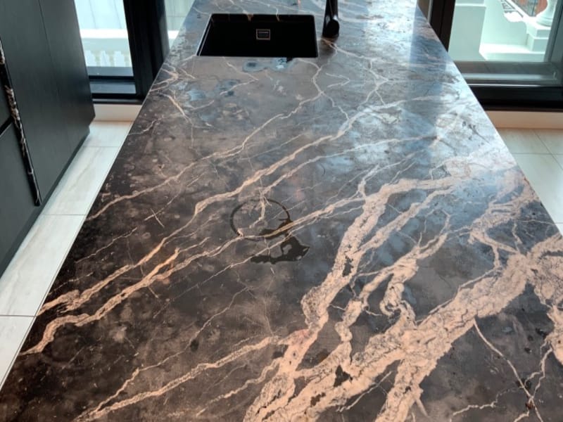 Black and cream marble benchtop before honing and Satin Tuffskin